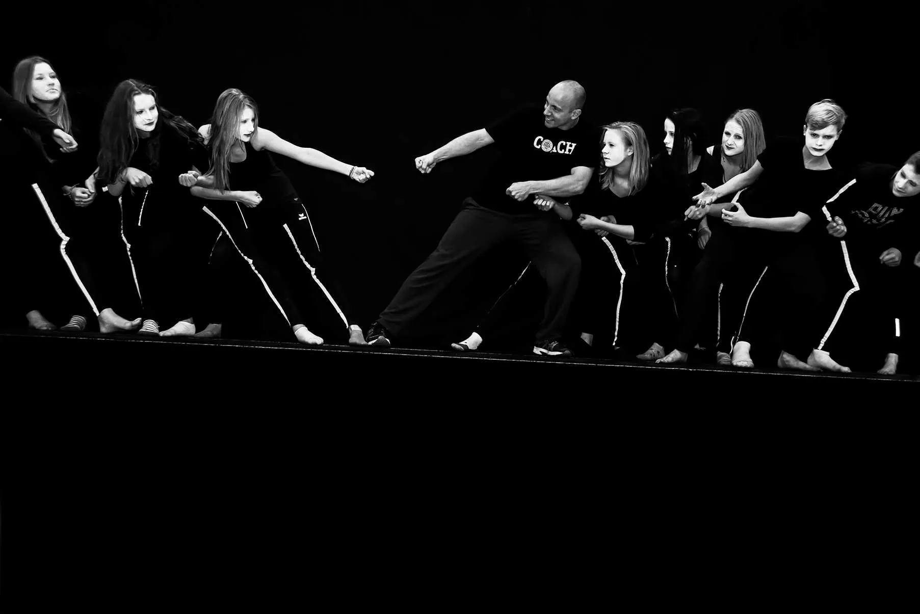 group of young performers lined up demonstrating body coordination