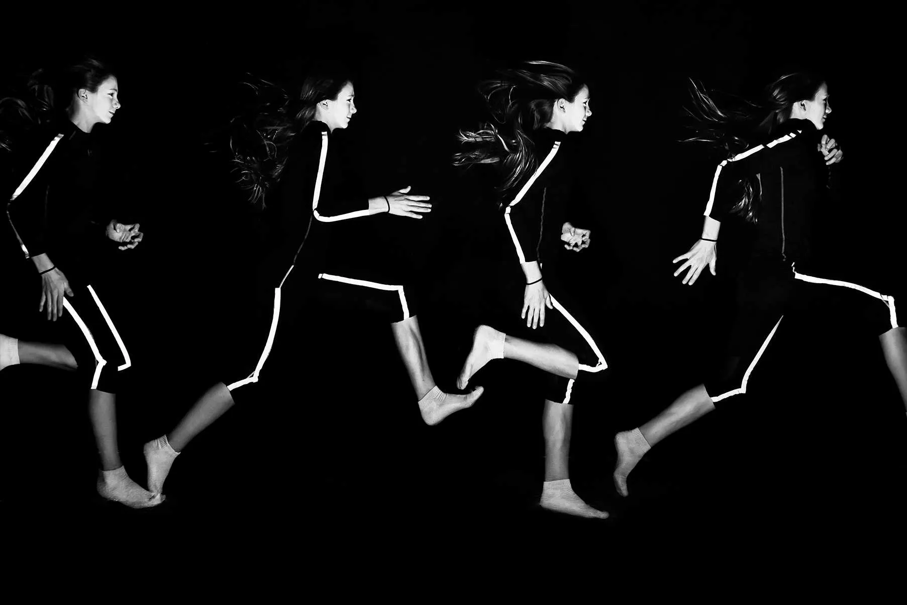 young athlete performing running motion sequence on black background
