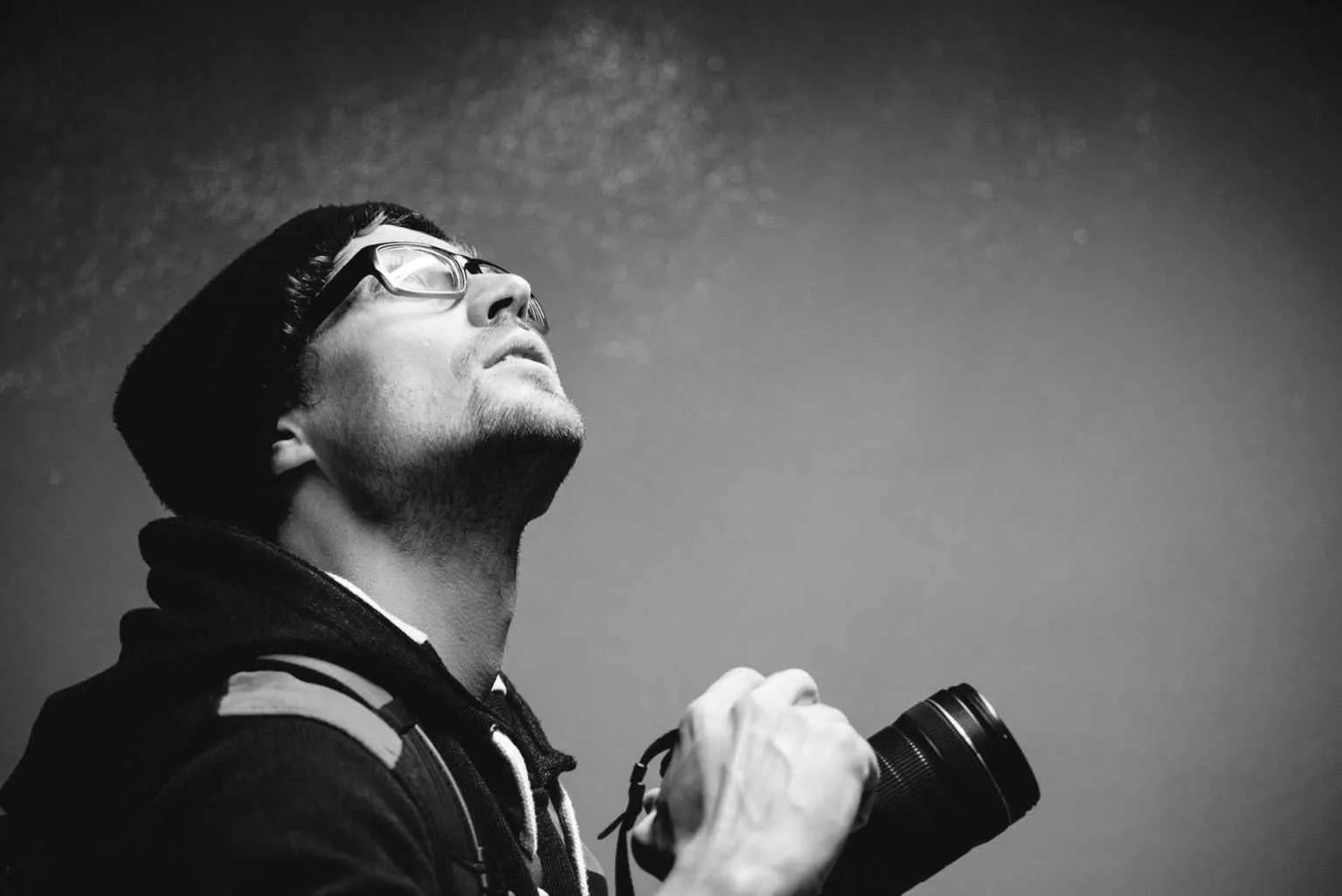 Side profile of photographer in hoody looking away