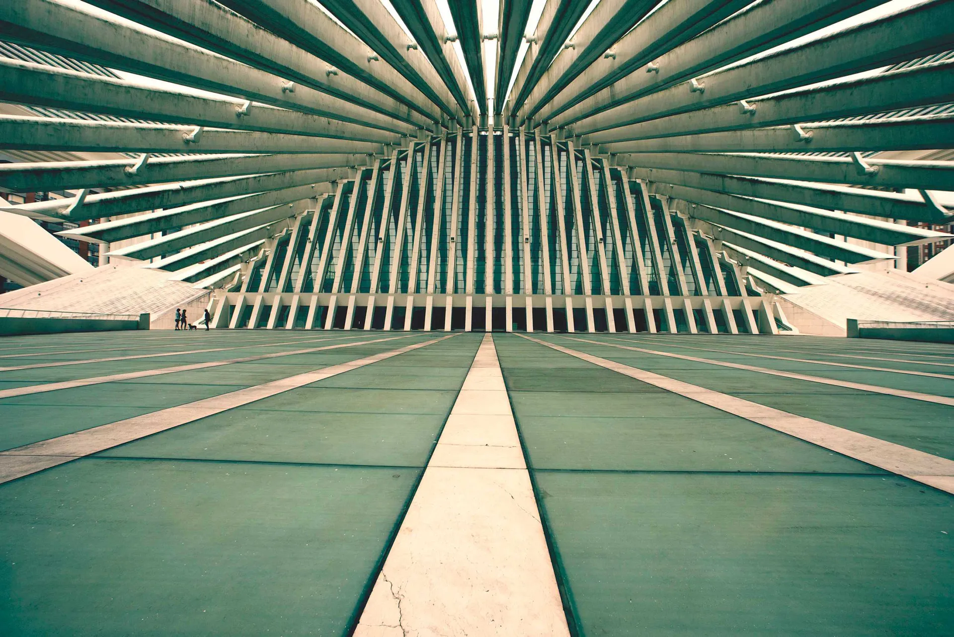 Symmetrical modern architectural structure with repeating concrete beams and strong perspective lines.